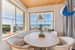 Living room small dining area with ocean views at Whaletopia